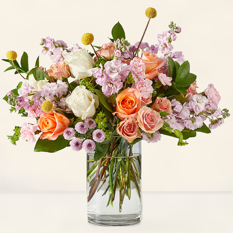 Fresh pastel roses bouquet with cream and peach roses, hand-tied market style arrangement