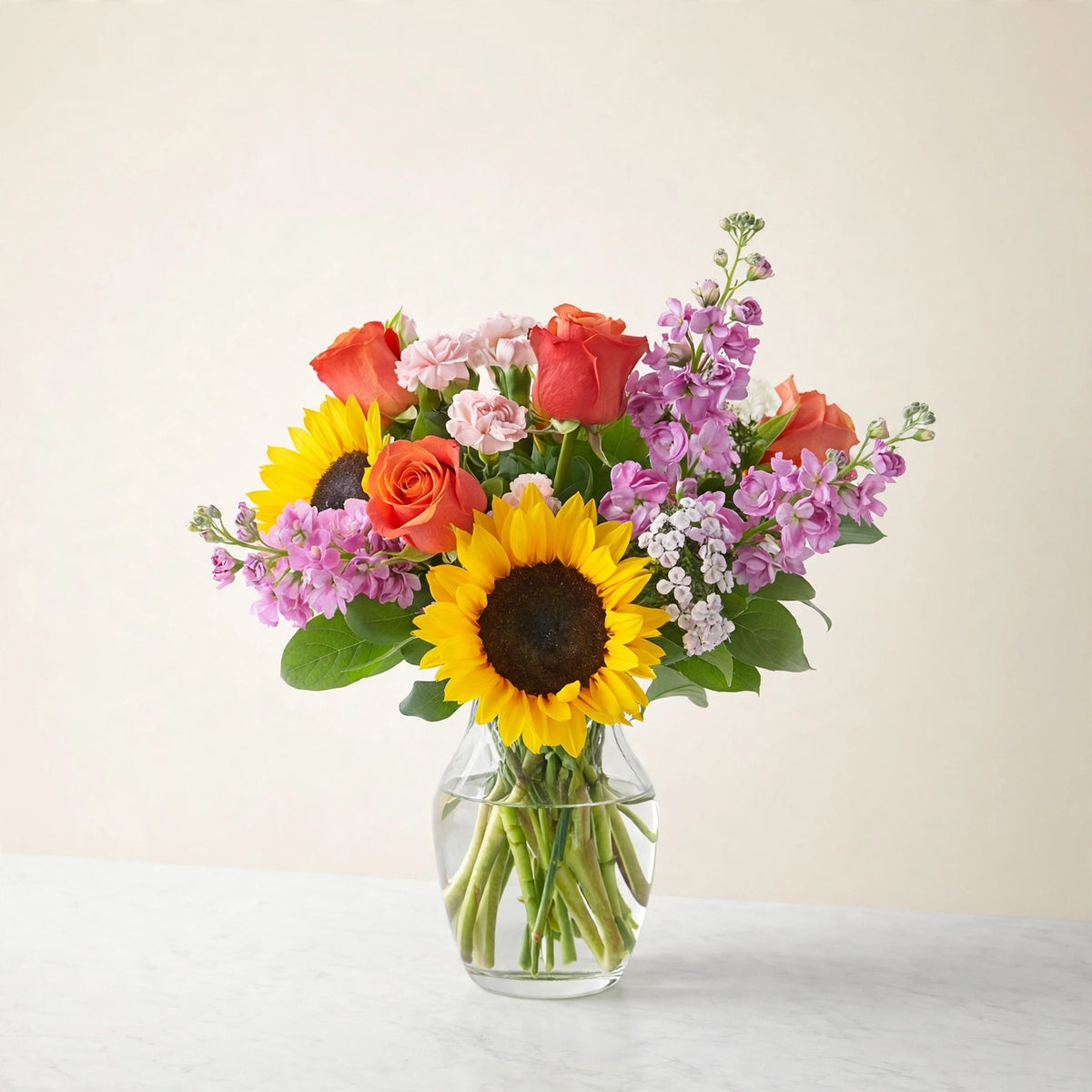Yellow Brick Road Bouquet — sunflowers with roses and seasonal blooms in a clear glass vase, hand-arranged by LaLa Florist in Baldwin Park