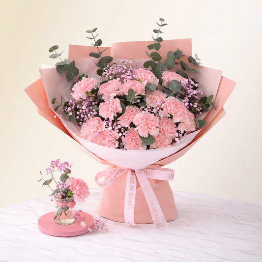Mother's Day Pink Carnation Bouquet — pink carnations with baby's breath and eucalyptus hand-wrapped in pink paper, by LaLa Florist in Baldwin Park