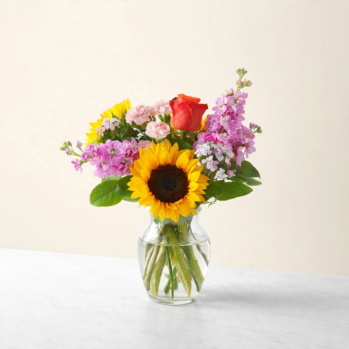 Yellow Brick Road Bouquet — sunflowers with roses and seasonal blooms in a clear glass vase, hand-arranged by LaLa Florist in Baldwin Park, front view