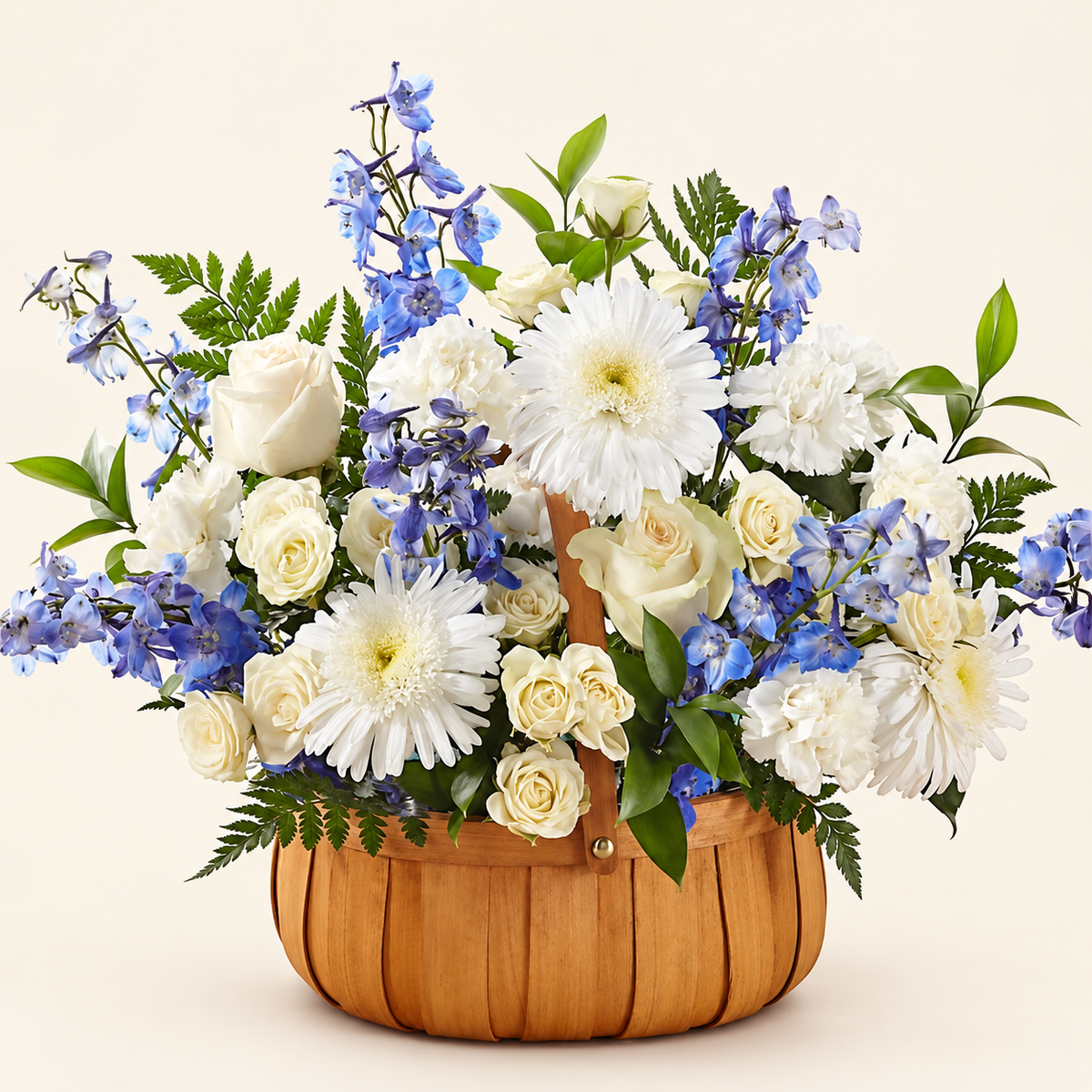 White and blue sympathy flower basket with roses, delphinium, carnations and daisies hand-arranged in a wicker basket, front view
