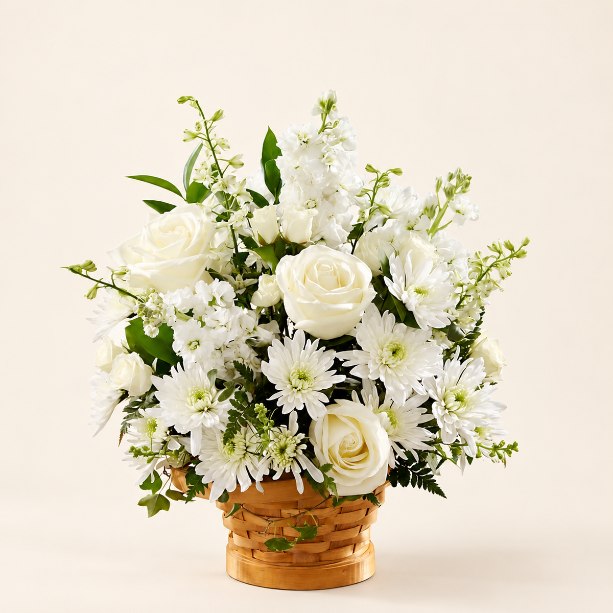 White sympathy basket with roses and chrysanthemums