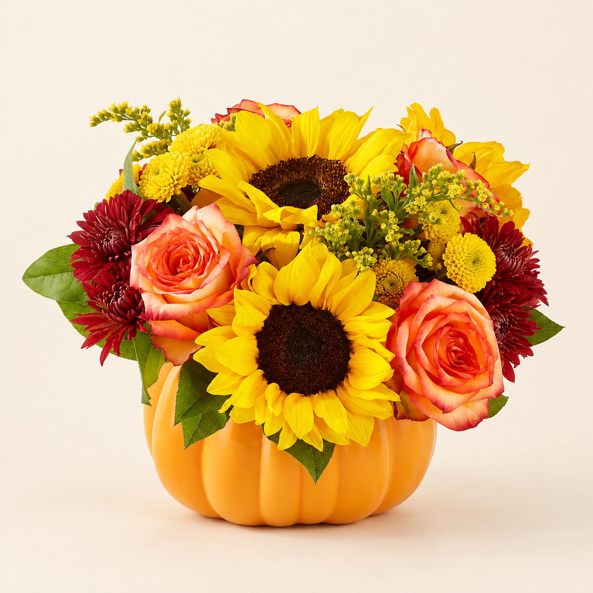 Fall pumpkin flower arrangement with sunflowers, roses and solidago
