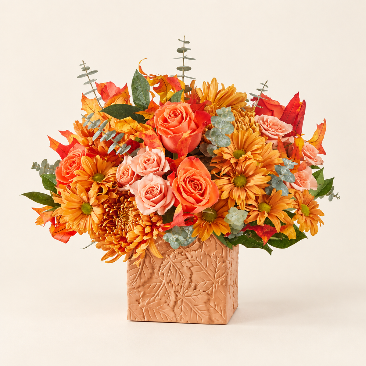 Fall flower arrangement with orange roses, daisies and seasonal blooms
