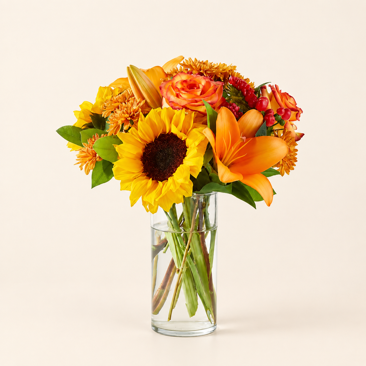Fall Day bouquet with sunflowers, roses and lilies in glass vase, front view
