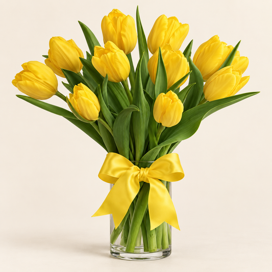 Sunny yellow tulip vase with fresh yellow tulips tied with a yellow bow in a clear glass vase, hand-arranged by Baldwin Park florist