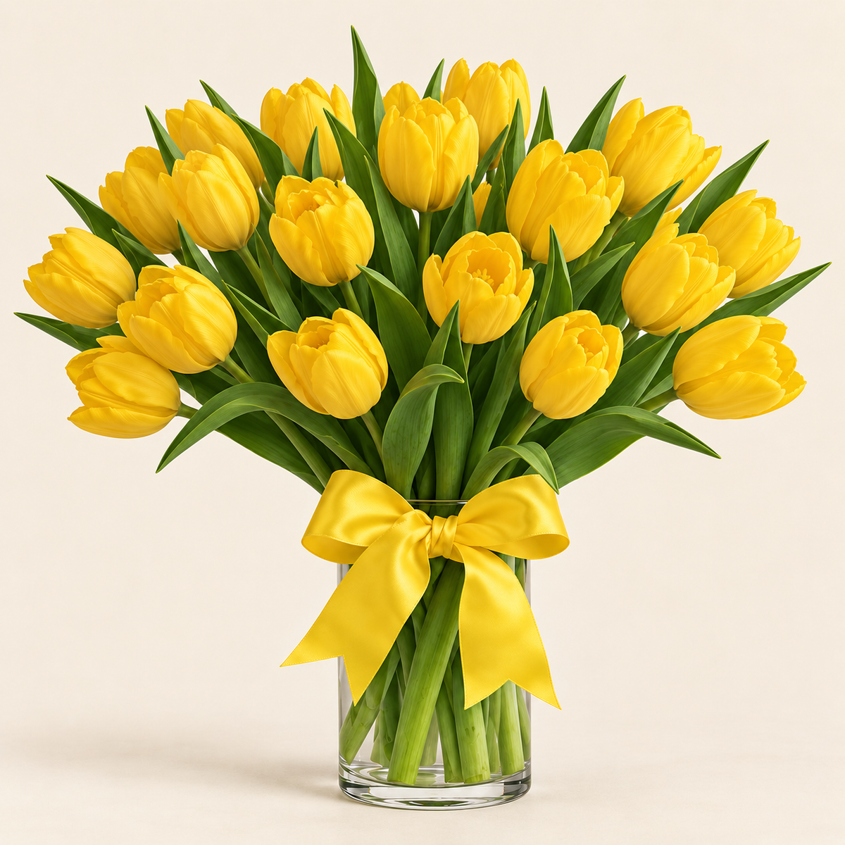 Bright yellow tulips bouquet — cheerful fresh-cut yellow tulips with bow in glass vase