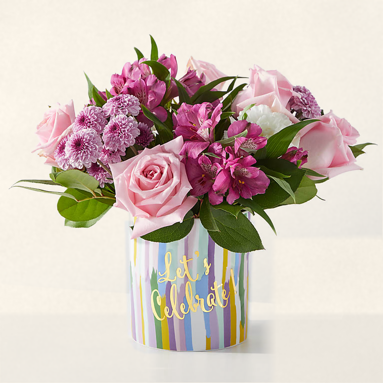 Party Starter bouquet with pink roses and pink-purple blooms in a Let's Celebrate striped keepsake vase, hand-arranged by Baldwin Park florist