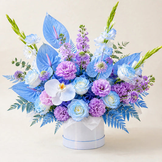 Blue Horizon Box — blue anthuriums, light blue roses, purple blooms and a white orchid in a white round box by LaLa Florist in Baldwin Park