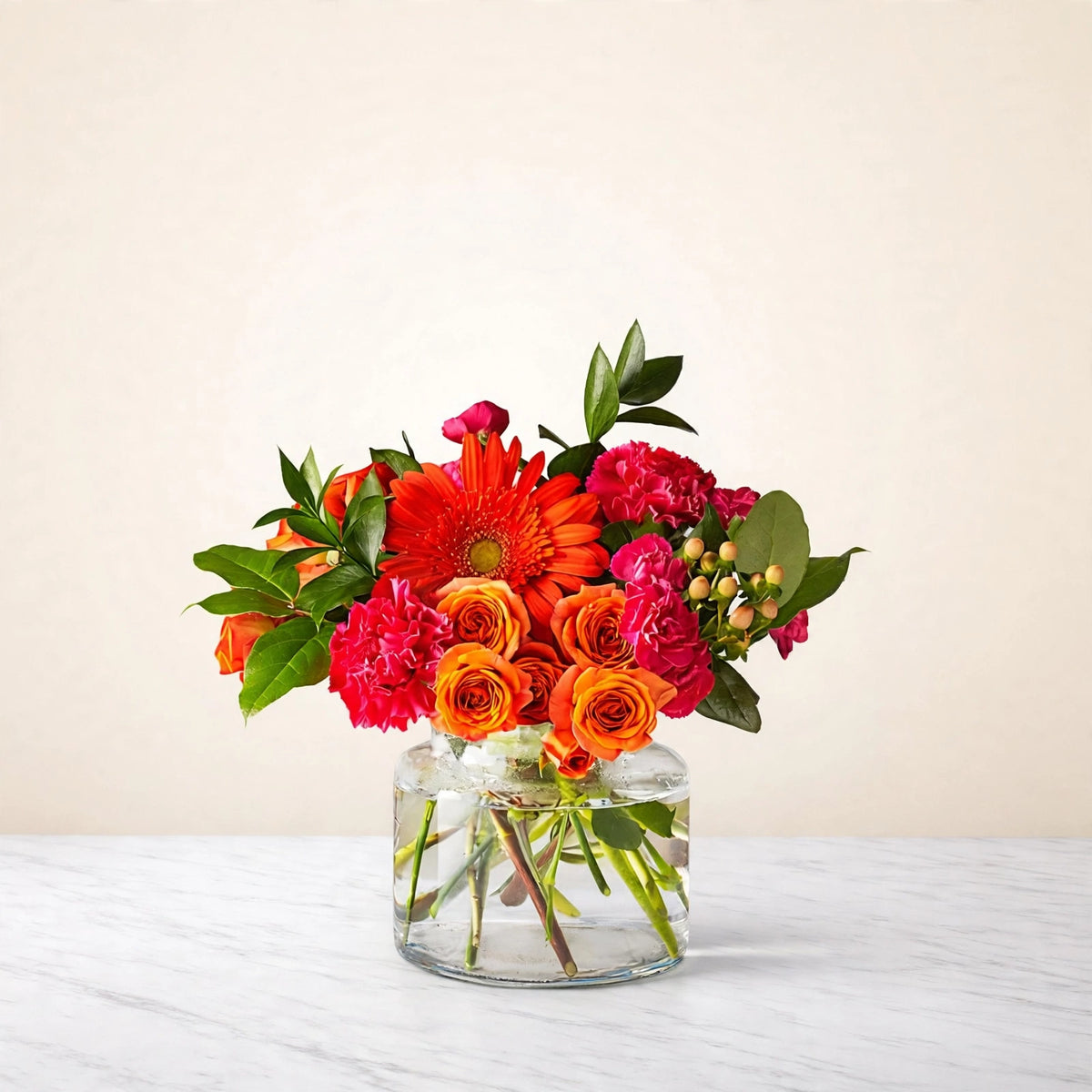 Fiesta Bouquet — orange gerbera daisies, orange and hot pink roses, pink carnations and orange spray roses in a clear glass vase, hand-arranged by LaLa Florist in Baldwin Park