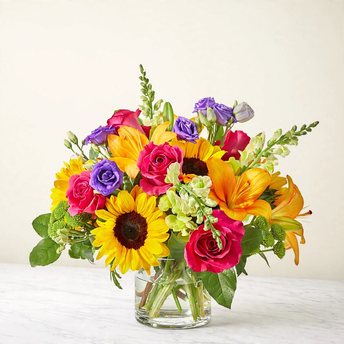 Best Day Bouquet — sunflowers, yellow lilies, hot pink roses, purple lisianthus and green hydrangea in a clear glass vase, hand-arranged by LaLa Florist in Baldwin Park