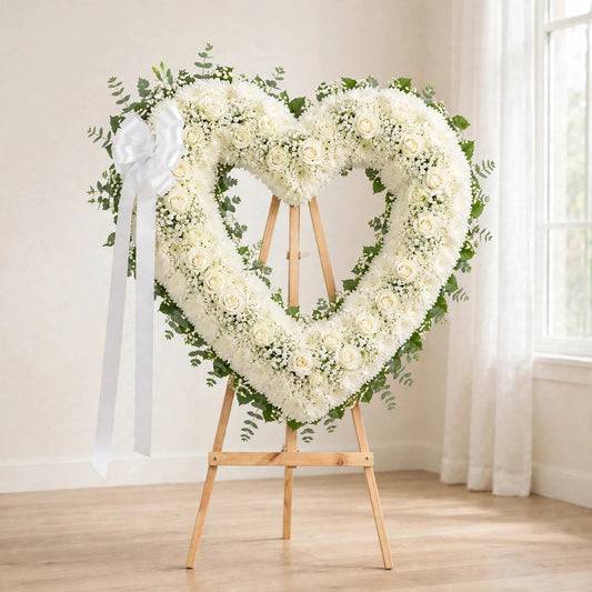 Classic White Heart Sympathy Wreath with white blooms and a white ribbon on a standing easel by LaLa Florist, Baldwin Park funeral flowers