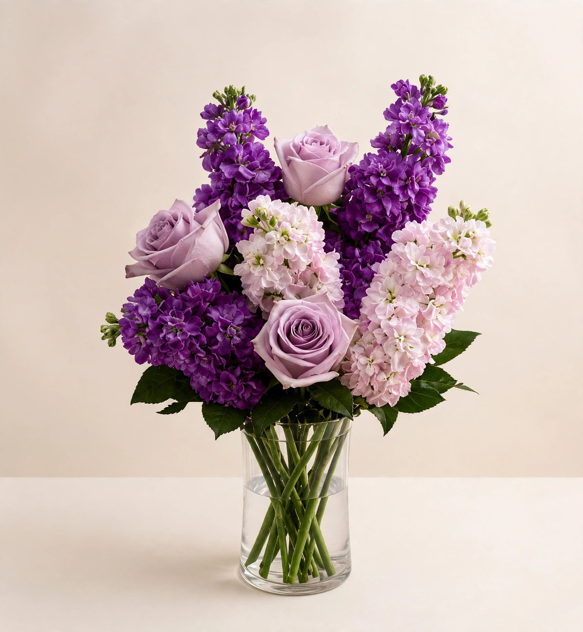 Lavender Sweet Devotion — lavender roses and purple stock flowers in a clear glass vase by LaLa Florist in Baldwin Park