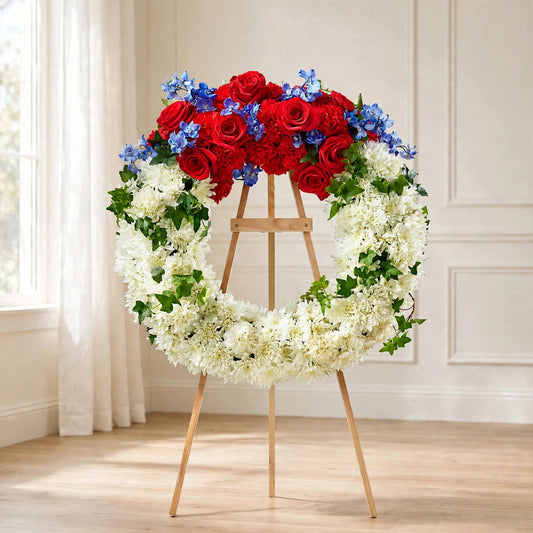 Patriotic Passion Wreath with red roses, white chrysanthemums and blue hydrangea on a standing easel by LaLa Florist, Baldwin Park funeral flowers