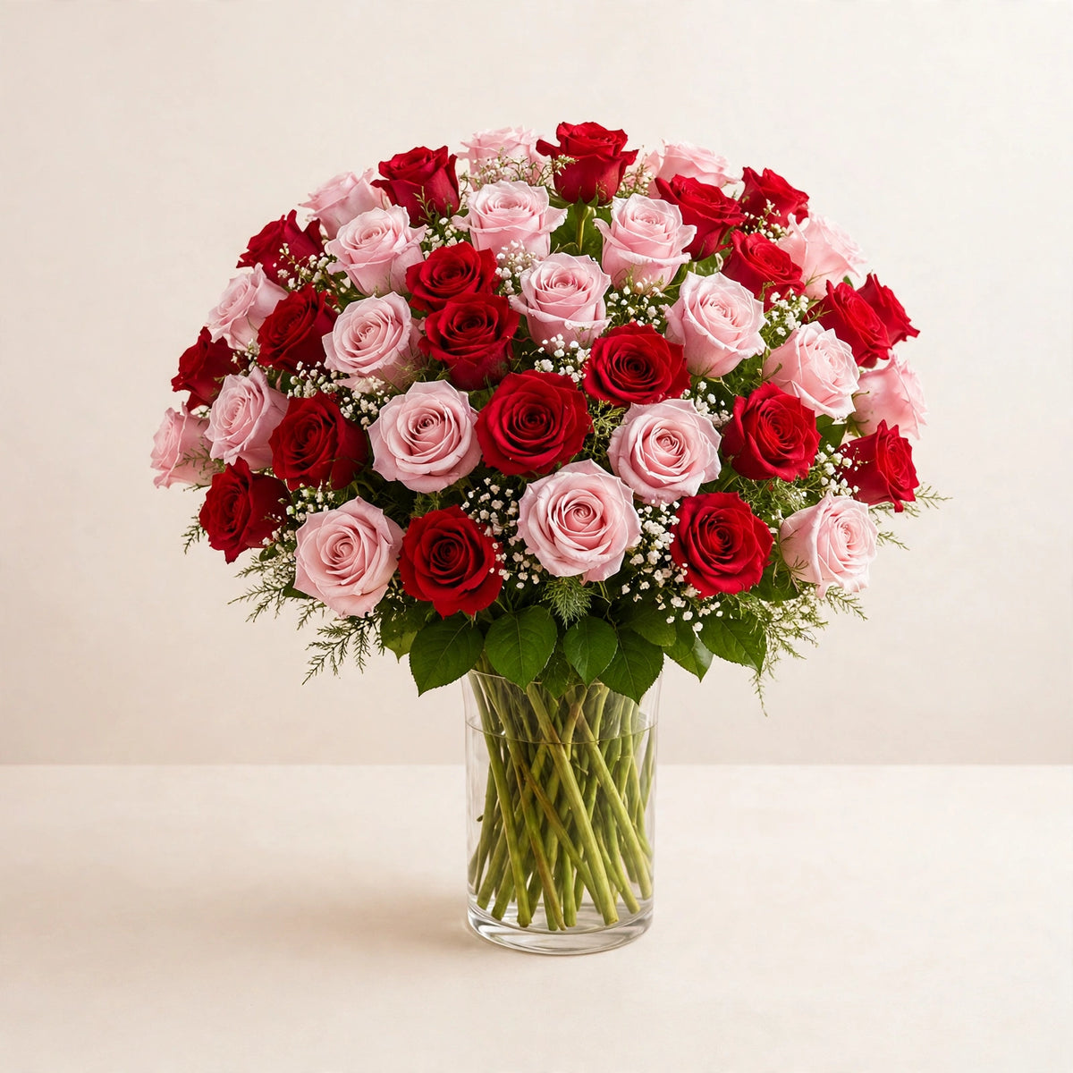 Romantic Blush Rose Arrangement — red and blush pink roses in a clear glass vase by LaLa Florist in Baldwin Park