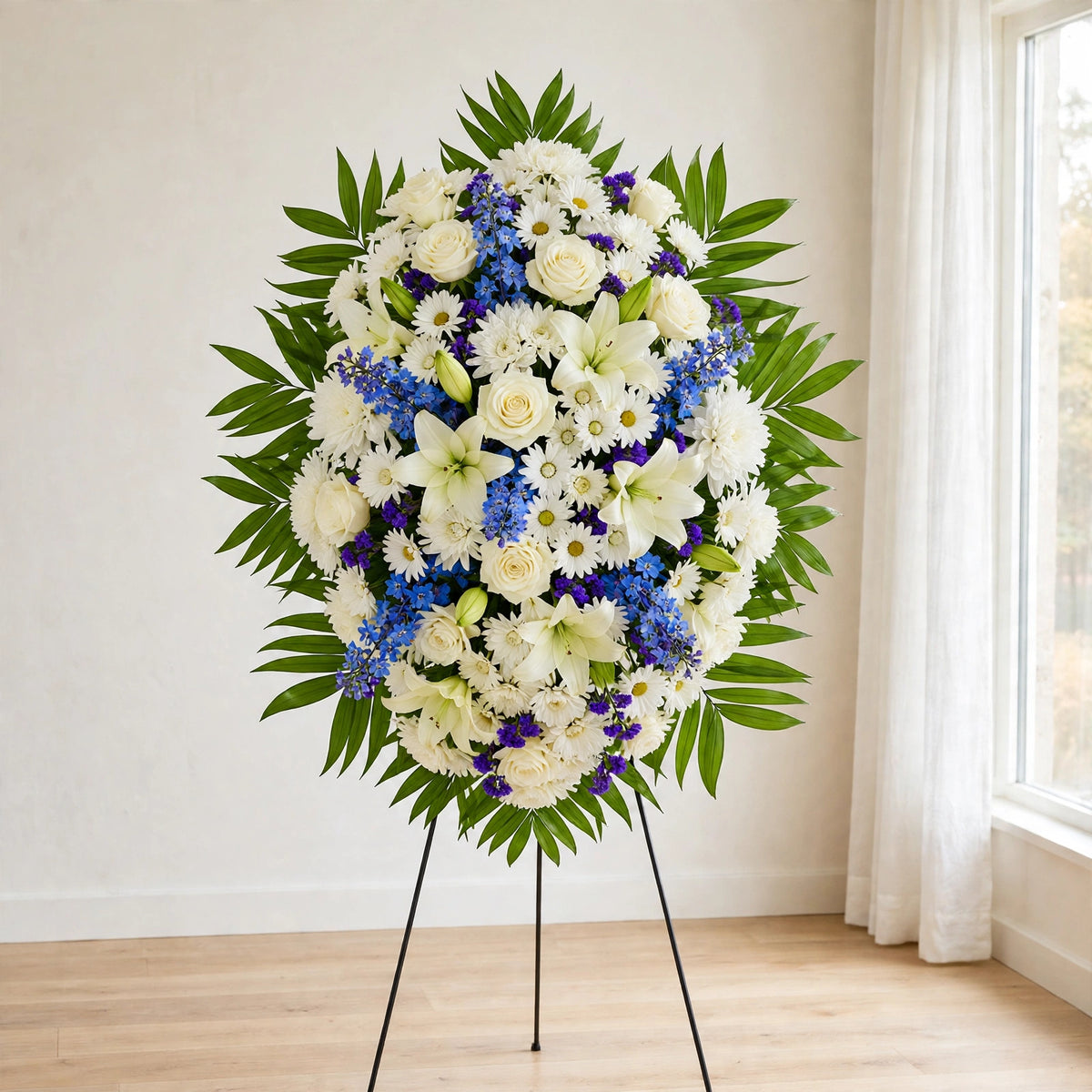 Front view of the White & Blue standing spray on a standing easel by LaLa Florist, Baldwin Park funeral flowers
